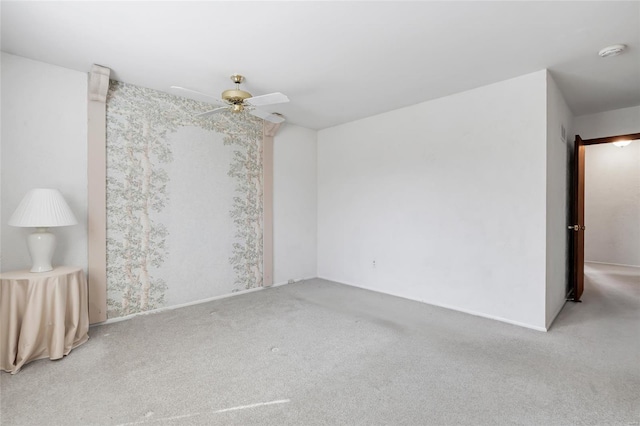 empty room with ceiling fan and carpet flooring