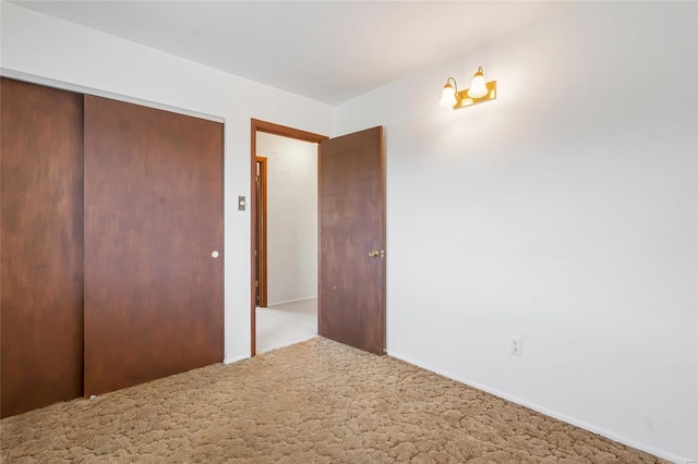 unfurnished bedroom featuring a closet and carpet floors