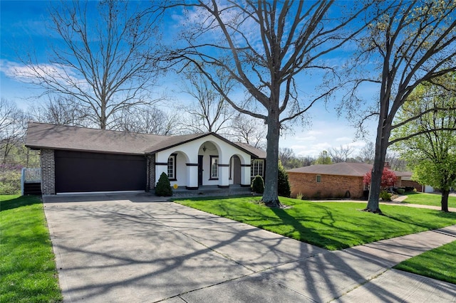 view of front facade with a garage, concrete driveway, stucco siding, brick siding, and a front lawn