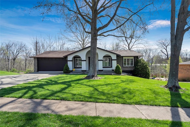 view of front of house with a front yard, driveway, a garage, and stucco siding