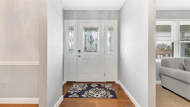 entryway featuring wood finished floors and baseboards