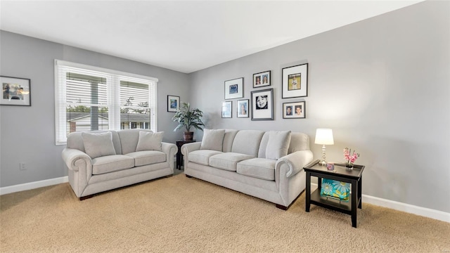 carpeted living room with baseboards