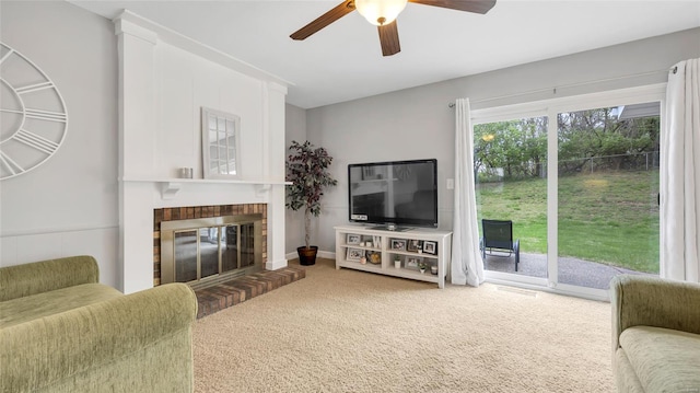 living area with carpet flooring, a fireplace, and a ceiling fan