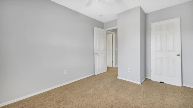 unfurnished bedroom featuring baseboards, ceiling fan, and carpet