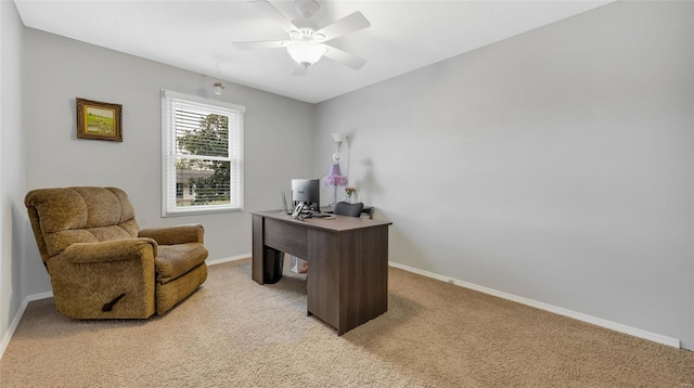 home office with light carpet, ceiling fan, and baseboards