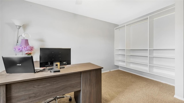 carpeted home office featuring baseboards