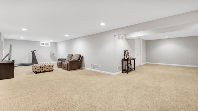 sitting room with visible vents, recessed lighting, and light colored carpet