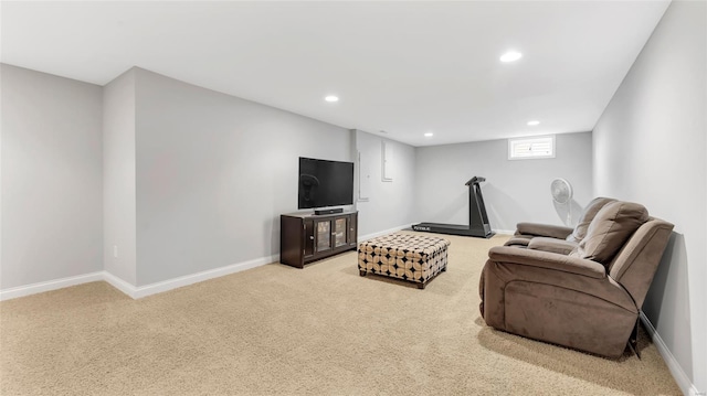 carpeted living area featuring recessed lighting and baseboards