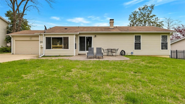 back of house with a lawn, a patio, fence, an attached garage, and driveway