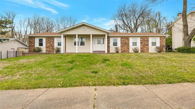 ranch-style house featuring a detached garage, a front yard, fence, and brick siding