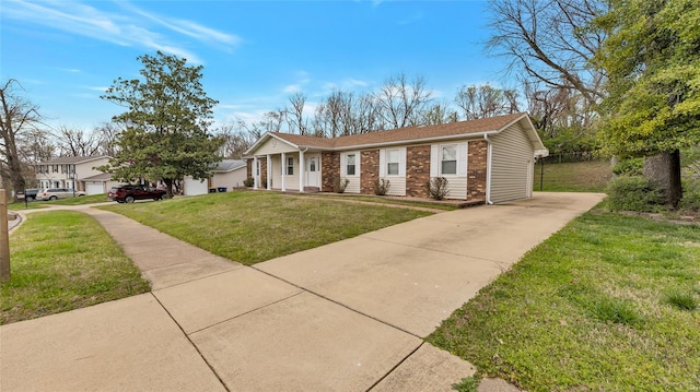 ranch-style home with concrete driveway, a front yard, and brick siding