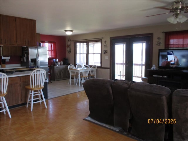 living room with french doors and ceiling fan