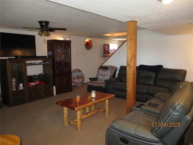 carpeted living area featuring a ceiling fan
