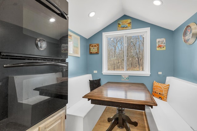 dining space with vaulted ceiling and recessed lighting