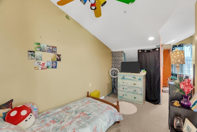 carpeted bedroom with ceiling fan and lofted ceiling