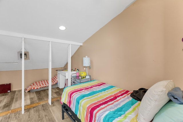 bedroom with wood finished floors, lofted ceiling, and recessed lighting