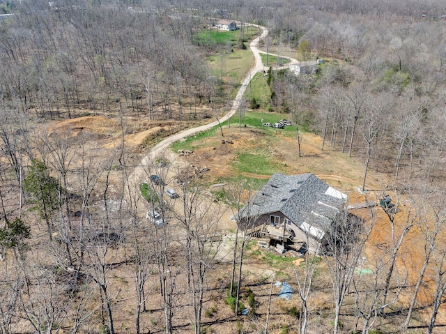 aerial view featuring a wooded view and a rural view
