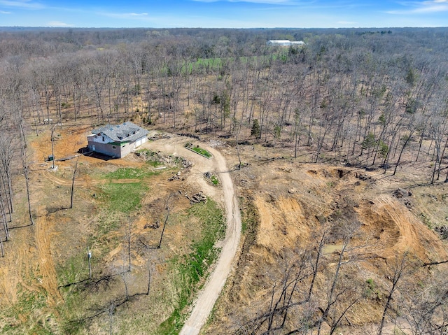 birds eye view of property featuring a forest view and a rural view