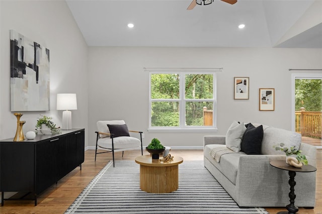 living room featuring recessed lighting, lofted ceiling, light wood-style flooring, and ceiling fan