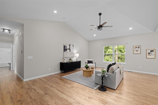 living area featuring light wood finished floors, visible vents, a ceiling fan, and lofted ceiling