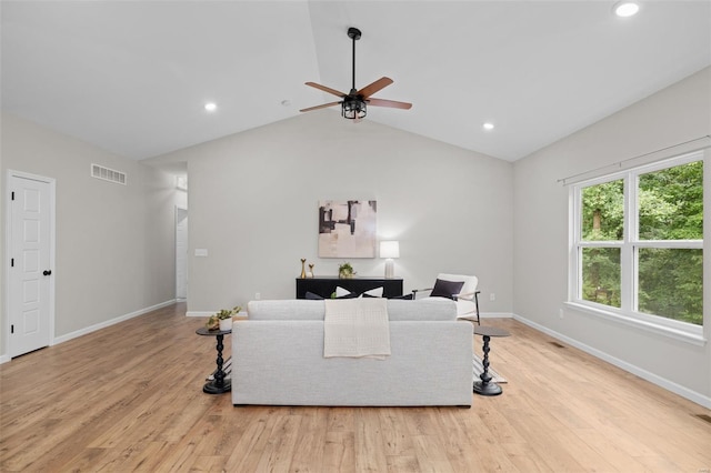 living room featuring baseboards, visible vents, light wood-type flooring, and a ceiling fan