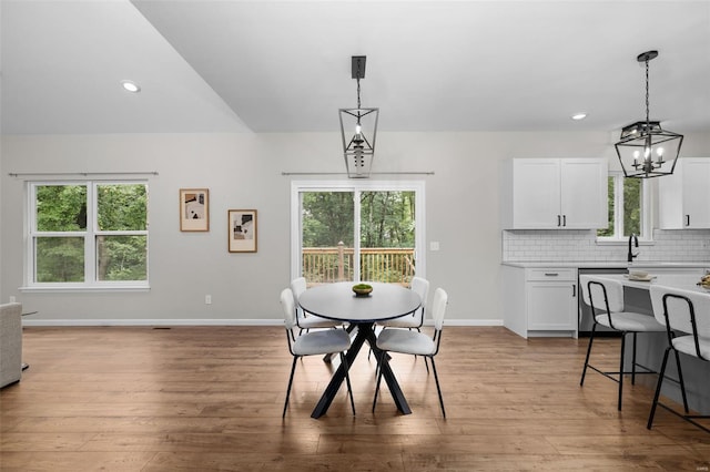 dining space featuring a chandelier, light wood finished floors, and plenty of natural light
