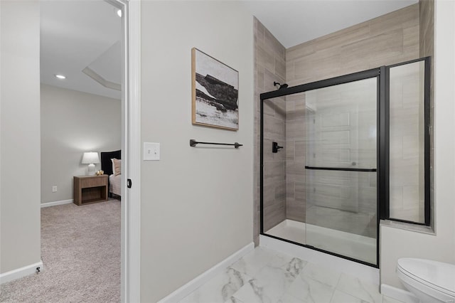 ensuite bathroom featuring toilet, baseboards, a shower stall, and marble finish floor