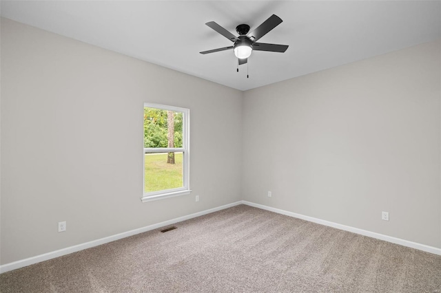 unfurnished room featuring ceiling fan, visible vents, baseboards, and carpet floors