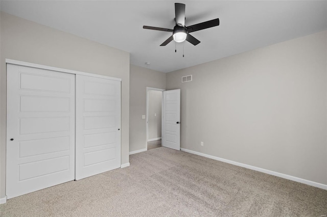 unfurnished bedroom featuring visible vents, a closet, baseboards, and carpet floors