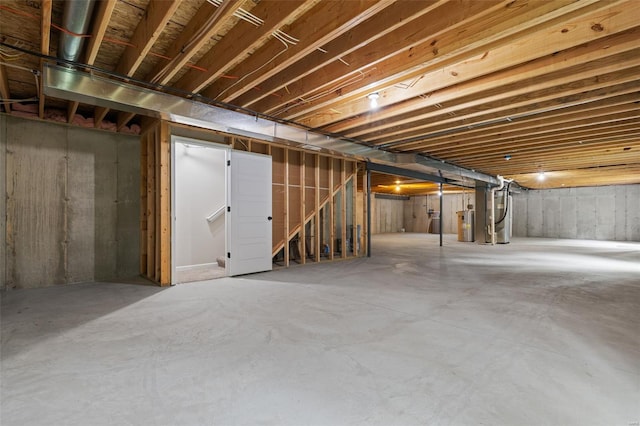unfinished below grade area featuring stairway, water heater, and heating unit