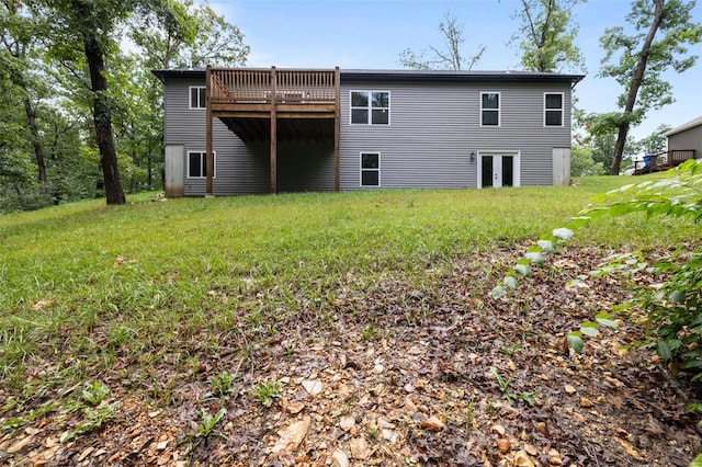 back of house featuring a deck and a lawn