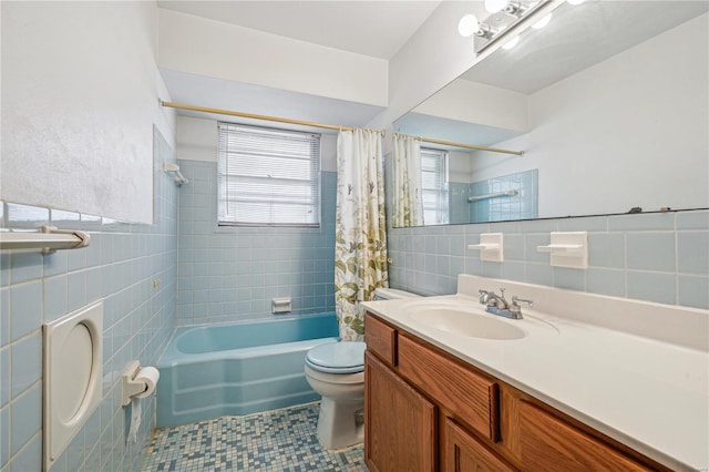 bathroom with vanity, tile patterned flooring, toilet, shower / bath combo, and tile walls