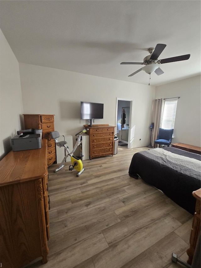 bedroom with a ceiling fan and wood finished floors
