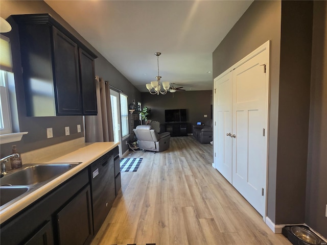 kitchen featuring a chandelier, open floor plan, light countertops, light wood-style floors, and dishwasher