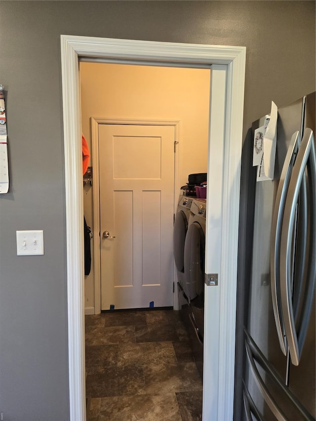 washroom with stone finish floor and laundry area