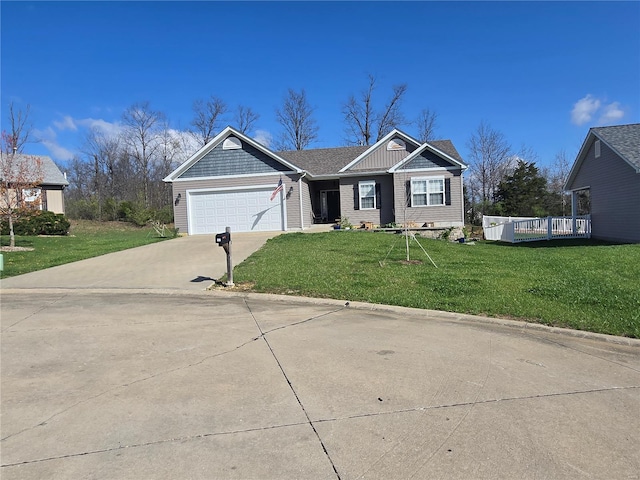 view of front of property featuring driveway, a garage, and a front lawn