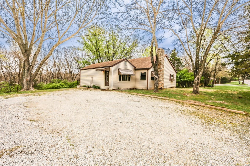 view of front of property with a front lawn and a chimney
