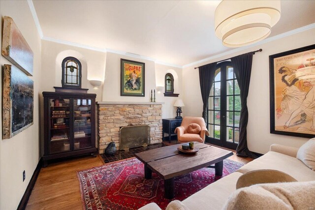 living room with baseboards, french doors, ornamental molding, and wood finished floors