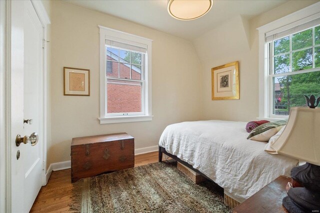 bedroom featuring baseboards and wood finished floors