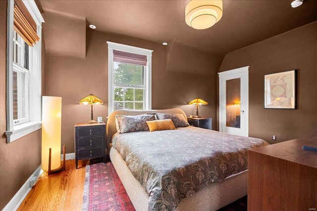 bedroom featuring baseboards and wood finished floors