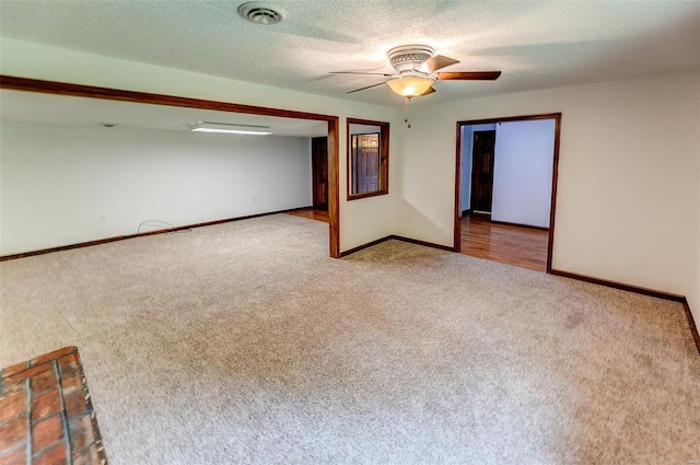 unfurnished room with carpet floors, baseboards, ceiling fan, and visible vents