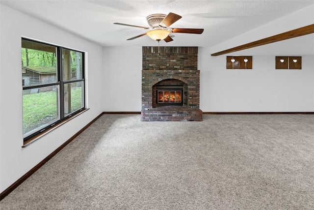 unfurnished living room featuring carpet floors, a textured ceiling, and baseboards