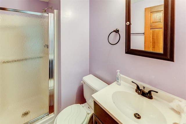 full bath featuring vanity, a shower stall, and toilet