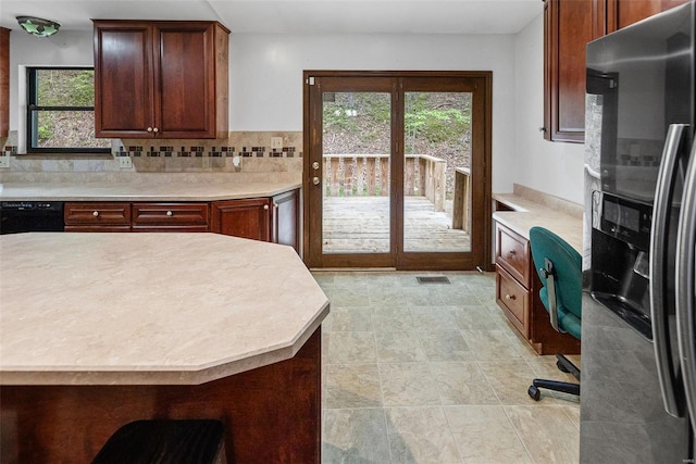 kitchen with light countertops, a wealth of natural light, and black appliances