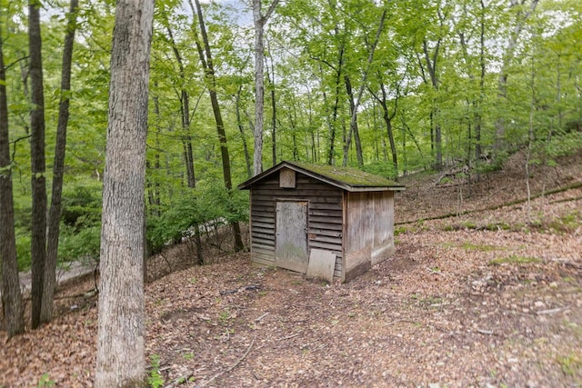 view of shed with a view of trees