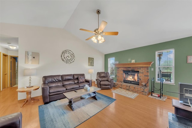 living room featuring ceiling fan, a brick fireplace, wood finished floors, and a healthy amount of sunlight