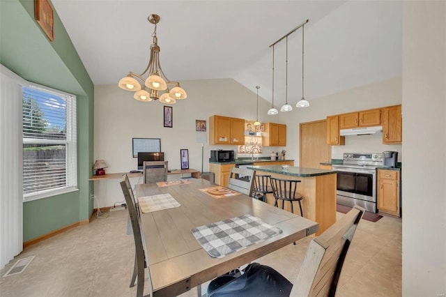 dining space featuring baseboards, a chandelier, light tile patterned flooring, visible vents, and high vaulted ceiling