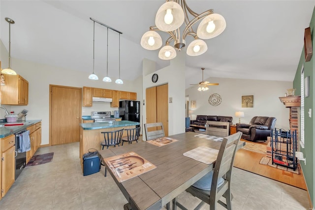 dining room featuring light tile patterned floors, ceiling fan with notable chandelier, and vaulted ceiling