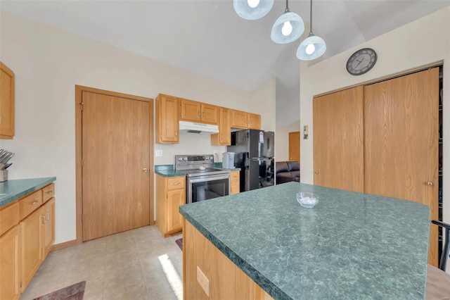 kitchen with dark countertops, freestanding refrigerator, under cabinet range hood, and stainless steel electric range