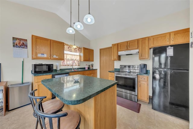kitchen featuring light tile patterned floors, black appliances, under cabinet range hood, a sink, and dark countertops